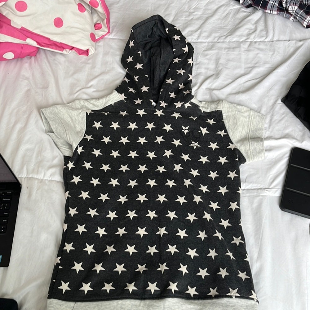 It’s a half sleeve sweatshirt, which is black and has off white stars In it